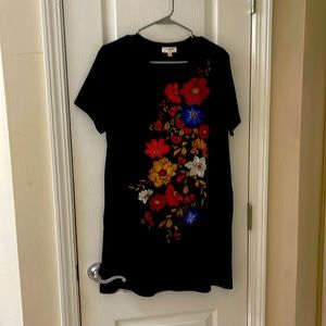 Black shift dress with floral embroidery.